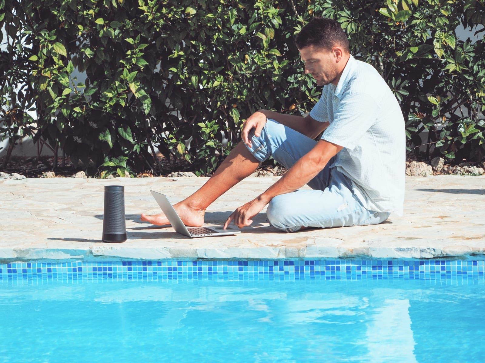 Pool route owner using a laptop poolside to respond to clients